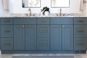 CE-Bath-Gallery1 A bathroom with blue cabinets and gold hardware.