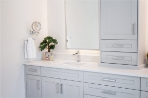 CE-Bath-Gallery10 A bathroom with white cabinets and a mirror.