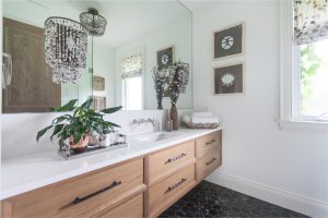 CE-Bath-Gallery2 A white bathroom with a wooden vanity and a mirror.