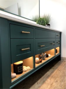 CE-Bath-Gallery3 A bathroom vanity with green cabinets and a mirror.