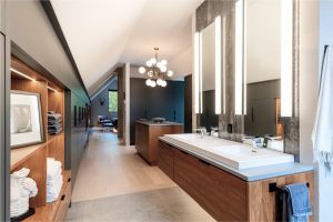 CE-Bath-Gallery7 A modern bathroom with two sinks and a mirror and wooden cabinets