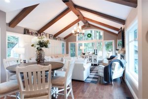 View this gallery image A living room with wood beams and white furniture.