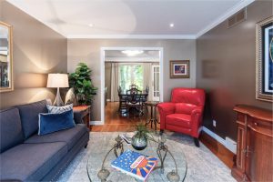 View this gallery image A living room with a blue couch and a coffee table.