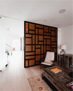 View this gallery image A living room with wooden walls and a coffee table.