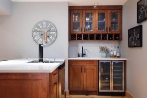 CE-Custom-Gallery15 A kitchen with custom cabinets, a wine cooler and a clock.