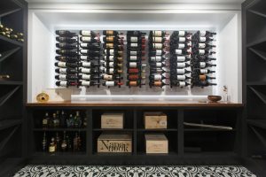 CE-Custom-Gallery19 A wine cellar with custom cabinets full of wine bottles.
