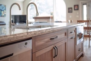 CE-Kitchen-Gallery22 A kitchen with granite counter tops and wooden cabinets underneath.