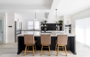 CE-Kitchen-Gallery23 A modern kitchen with a black island and stools.
