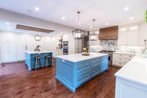 CE-Kitchen-Gallery28 A kitchen with blue and white cabinets with hardwood floors.