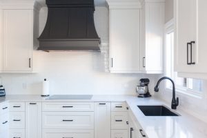 CE-Kitchen-Gallery34 A kitchen with white cabinets and black appliances.
