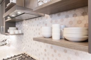 CE-Kitchen-Gallery38 A kitchen with wooden cabinets and a gray tiled backsplash.
