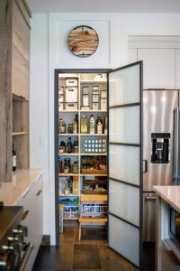 CE-Kitchen-Gallery40 An open pantry door in a kitchen.