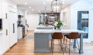 CE-Kitchen-Gallery42 A white kitchen with wooden floors and a bar stools.