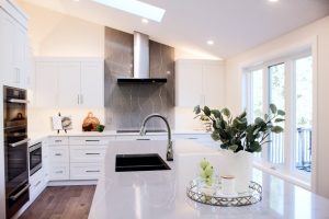 CE-Kitchen-Gallery5 A white kitchen with a skylight and a sink.