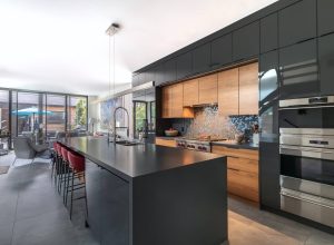CE-Kitchen-Gallery8 A modern kitchen with black cabinets and stainless steel appliances.